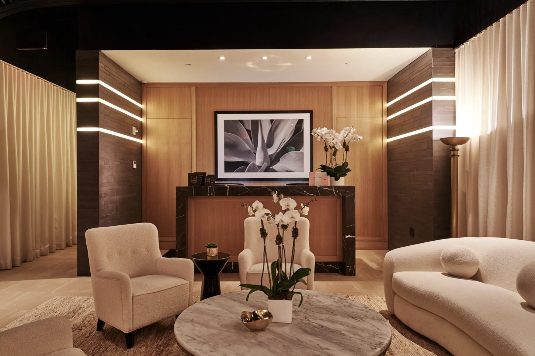 The Sullivan Club lounge — curved seating, warm wood, and marble