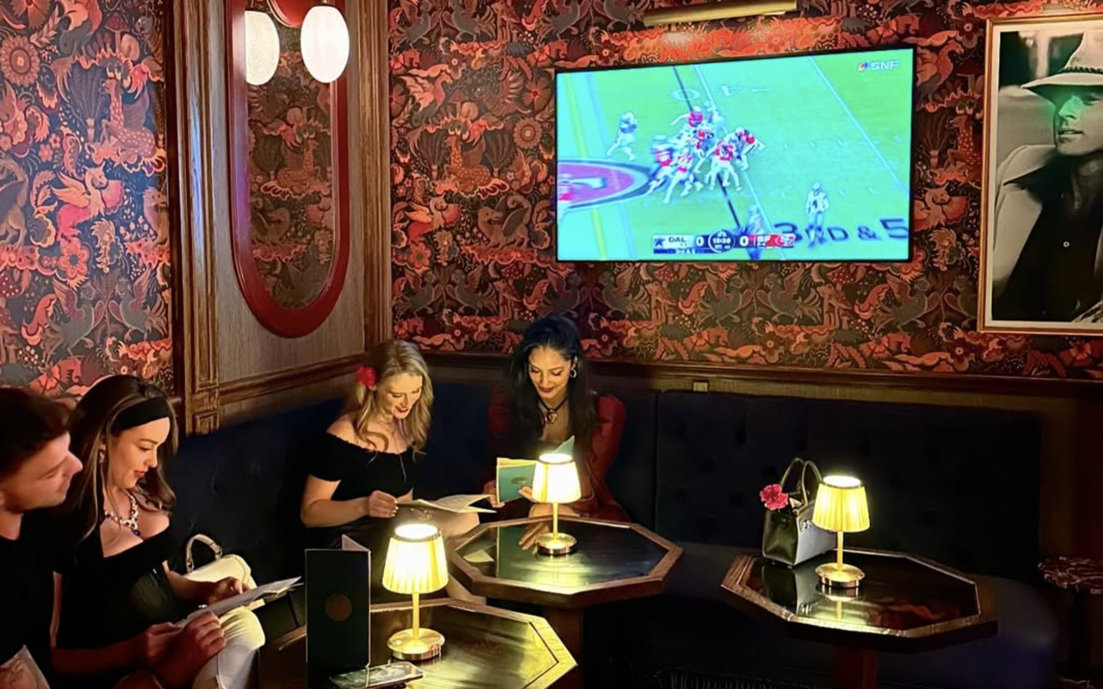 The lounge — the game on, table lamps lit